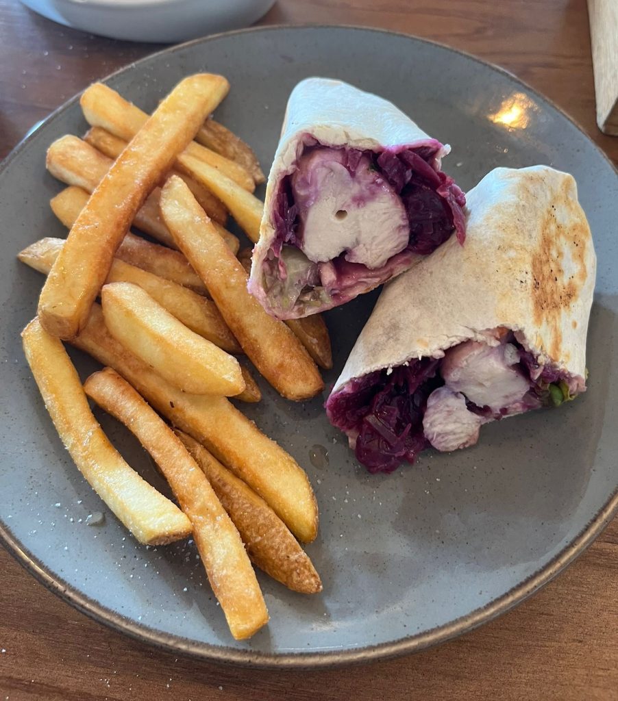 Garlic and herb chicken wrap with red cabbage slaw with a side of skin on fries