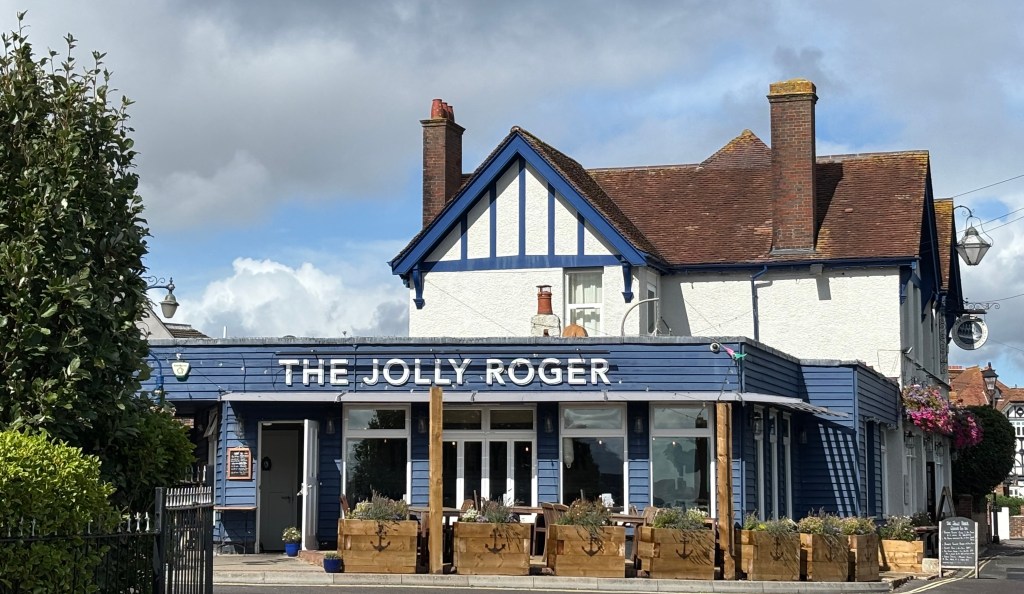 The front of Gosport pub The Jolly Roger. It had a blue painted facade and wooden planters with an anchor painted on the front